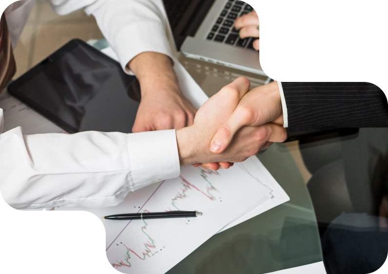 Business handshake over financial documents