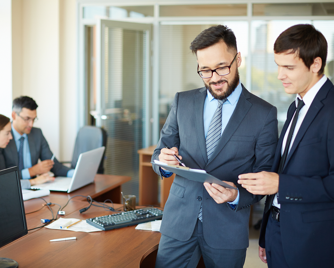 Banking recovery experts reviewing documents in an office